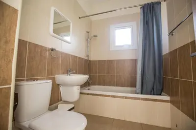 a bathroom with a toilet and a sink and a tub at Protaras Delfini Villa Dv5 in Protaras