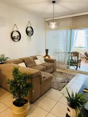 a living room with a couch and a table at Carisa Holiday rooms in Larnaka