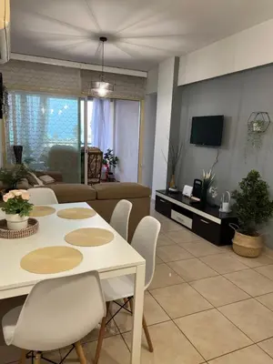 a living room with a white table and chairs at Carisa Holiday rooms in Larnaka