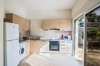 a kitchen with a white refrigerator and a dishwasher at Villa Delfini 5 in Protaras