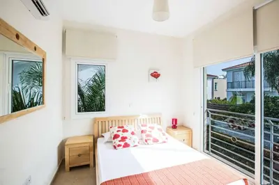 a bedroom with a bed and a large window at Villa Delfini 5 in Protaras