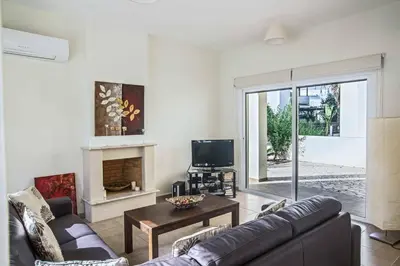 a living room with a couch and a tv at Villa Delfini 5 in Protaras