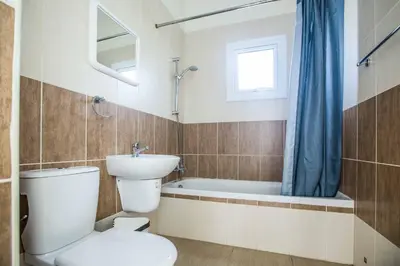 a bathroom with a toilet and a sink and a tub at Villa Delfini 5 in Protaras