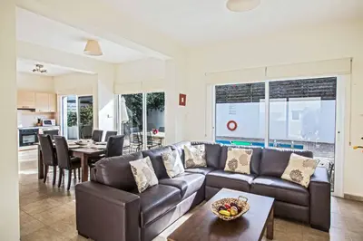 a living room with a couch and a table at Villa Delfini 5 in Protaras