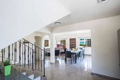 a dining room and living room with a dining table at Villa Delfini 16 in Protaras