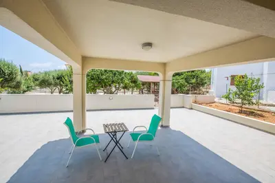 a patio with two chairs and a table on a patio at Villa Delfini 16 in Protaras