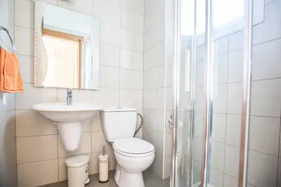 a bathroom with a toilet and a sink and a mirror at Villa Mesogeios ME25 in Protaras
