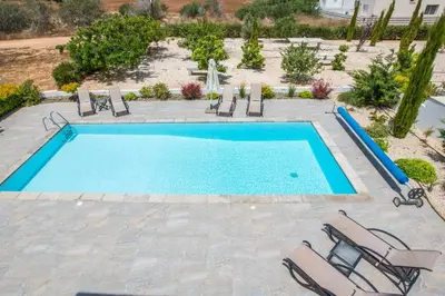a swimming pool with chaise lounge chairs and a swimming pool at Protaras Greco Villa CCV2 in Protaras