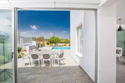 a patio with a table and chairs and a pool at Protaras Greco Villa CCV2 in Protaras