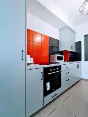 a large kitchen with white cabinets and an oven at Ayia Anna Apartment in Ayia Napa