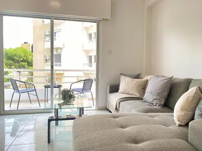a living room with a couch and a glass table at Phaedrus Living Down Town Flat Nestoras 301 in Limassol