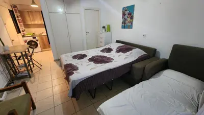 a small room with a bed and a couch at Ayia Napa sea view great location bars & beach in Ayia Napa
