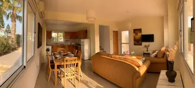 a living room with a couch and a table at Sunset Sea View Villa in Ayia Napa