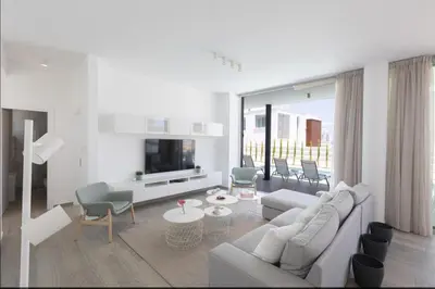 a white living room with a white couch and chairs at Protaras Olivine Villa Ol9 in Protaras