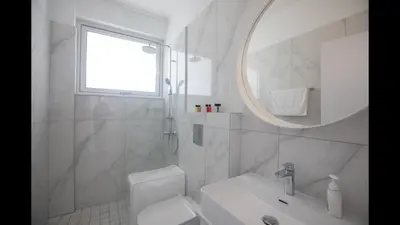 a white bathroom with a sink and a mirror at Protaras Olivine Villa Ol10 in Protaras