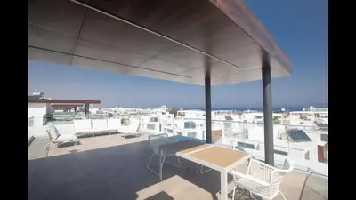 a balcony with a table and chairs on a building at Protaras Olivine Villa Ol10 in Protaras