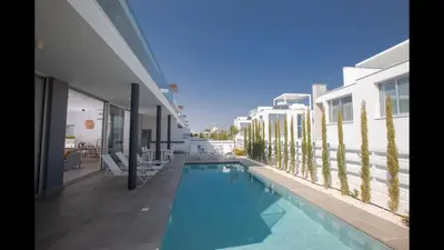 a swimming pool on the side of a building at Protaras Olivine Villa Ol10 in Protaras