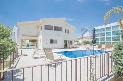 a balcony with a swimming pool and a house at Protaras Holiday Villa Dv16 in Protaras