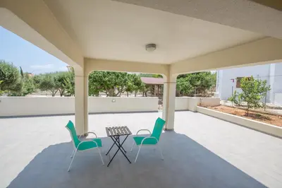 a patio with two chairs and a table on it at Protaras Holiday Villa Dv16 in Protaras