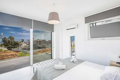 a bedroom with a bed and a large window at Villa Olivine Pearl 6 in Protaras