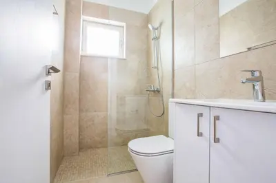 a bathroom with a shower and a toilet and a sink at Olivine Pearl OL20 in Protaras