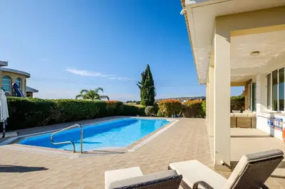 a swimming pool in front of a house at Cape Greco Villa Anastel 2 in Ayia Napa