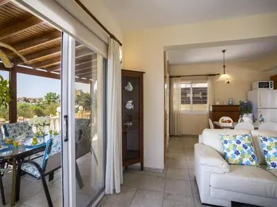 a living room with a white couch and a table at Protaras Villa Amber By The Sea in Protaras