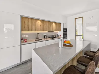 a kitchen with white cabinets and a counter top at Azure Villas by Marc in Protaras