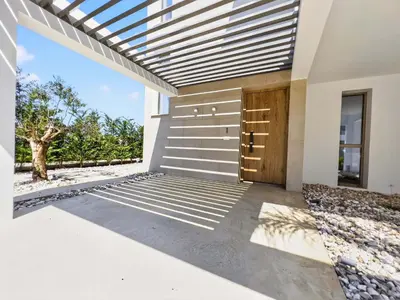 a facade of a house with a wooden door at Azure Villas by Marc in Protaras