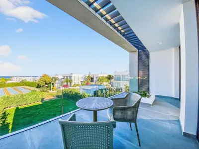 a patio with a table and chairs on a balcony at Azure Villas by Marc in Protaras