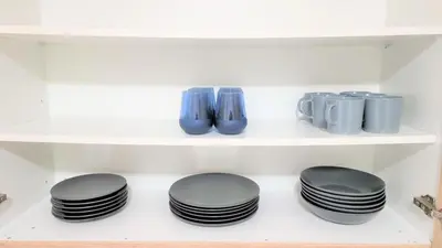 a row of black plates on a shelf at Coastal Getaway: 2 Apartments for up to 14 guests! Light-flooded and Spacious in Larnaka