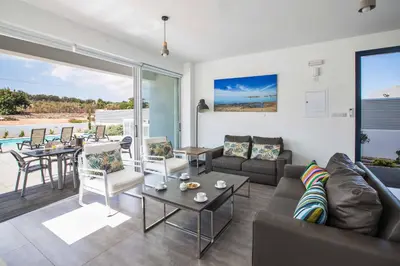 a living room with a couch and a table at Protaras Greco Villa CCV5 in Protaras