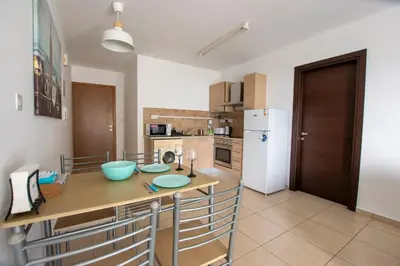 a kitchen with a table and a refrigerator at Glabur Stays - The Master Atelier - Nicosia City, Free Parking & Wifi, Welcomes You!!! in Nicosia