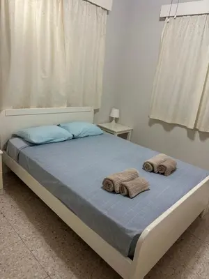a bedroom with a bed with towels on it at Leonidas Seaside in Meneou
