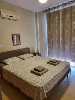 a bedroom with a bed with two towels on it at Villa Joia in Ayia Napa