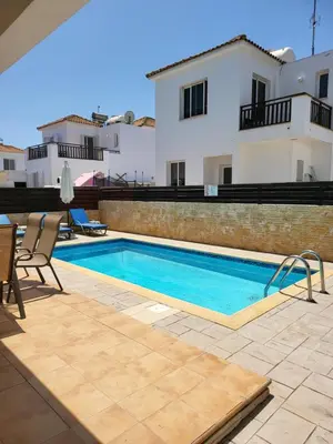 a swimming pool in front of a house at Villa Joia in Ayia Napa