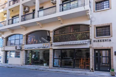 a building with a store front with windows at Gitane 1-Bedroom Apartment in Larnaca in Larnaka