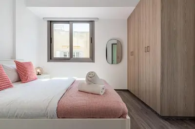 a bedroom with a large bed and a window at Crystal 2-Bedroom Apartment in Larnaca in Larnaka