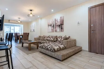 a living room with a couch and a table at Celeste 3-Bedroom Apartment in Larnaca in Larnaka