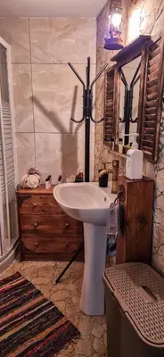 a bathroom with a white sink and a mirror at Angels Traditional House in Arminou