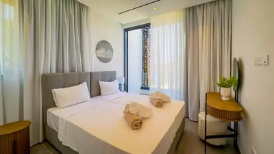 a hotel room with a bed with towels on it at Sunrise Beachfront Villas - Villa 1 in Paralimni