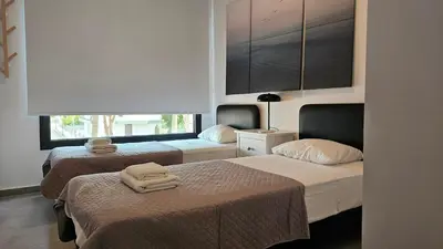 a hotel room with two beds and a window at STAY Anemone 19 in Protaras
