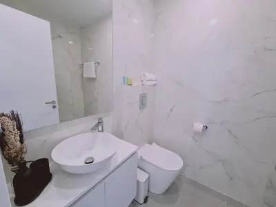 a white bathroom with a sink and a toilet at STAY Anemone 19 in Protaras