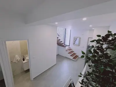 a white room with a staircase and a plant at STAY Anemone 19 in Protaras