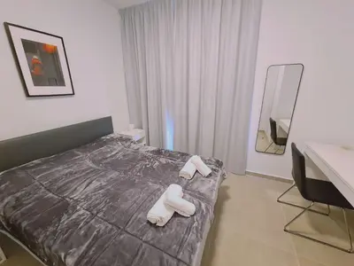 a bedroom with a bed with white slippers on it at STAY Anemone 20 in Protaras