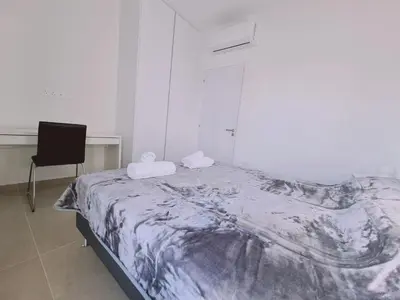 a bed in a room with a desk and a chair at STAY Anemone 20 in Protaras