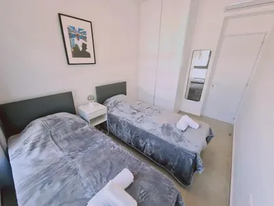 a bedroom with two beds and a mirror at STAY Anemone 20 in Protaras