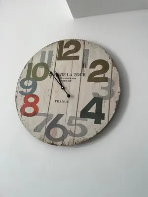 a clock is hanging on a wall at Gaia Seaview Apartment 1 in Larnaka