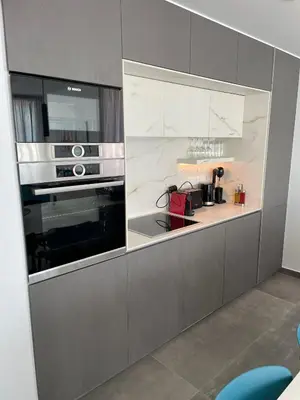 a kitchen with a stove and a microwave at Gaia Seaview Apartment 1 in Larnaka