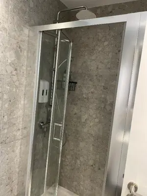 a shower with a glass door in a bathroom at Gaia Seaview Apartment 1 in Larnaka